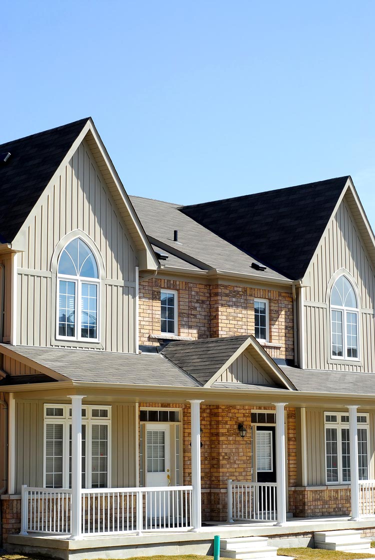 Modern side-by-side duplex with shared front yard in an urban neighborhood, representing missing middle housing