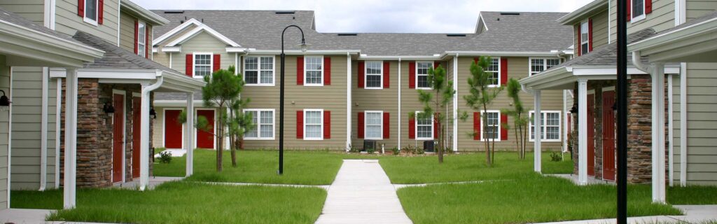 Cottage court community with small homes facing a shared central green space and walking area, exemplifying missing middle housing.
