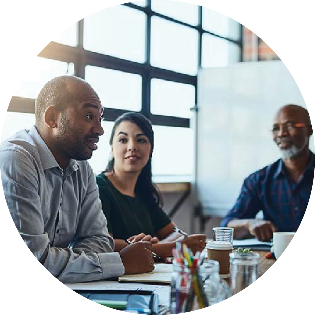 Group of people sitting at a table discussing business.